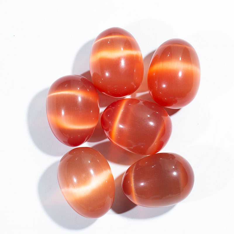 Venta al por mayor de huevo de cristal de piedra de ojo de gato naranja para masaje