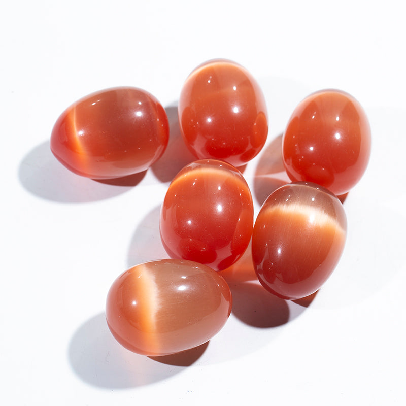 Venta al por mayor de huevo de cristal de piedra de ojo de gato naranja para masaje